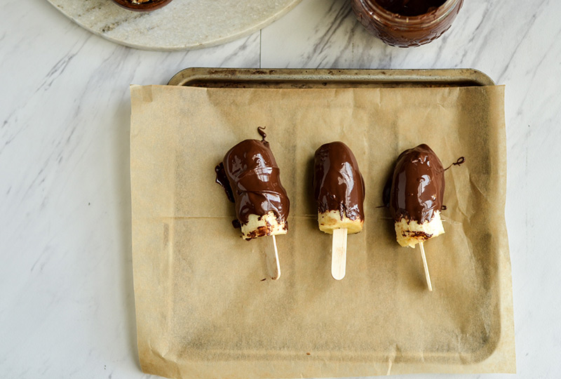 Frozen bananas dipped in melted chocolate