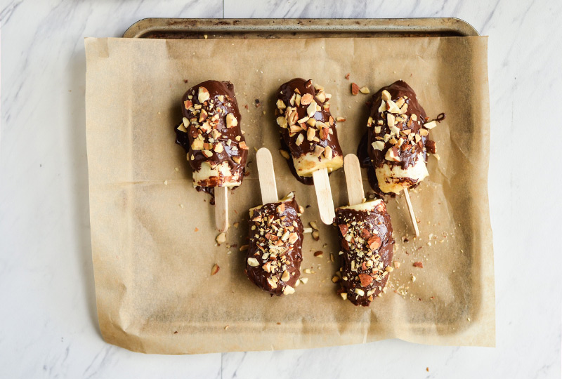 Frozen bananas dipped in melted chocolate and rolled in chopped nuts.