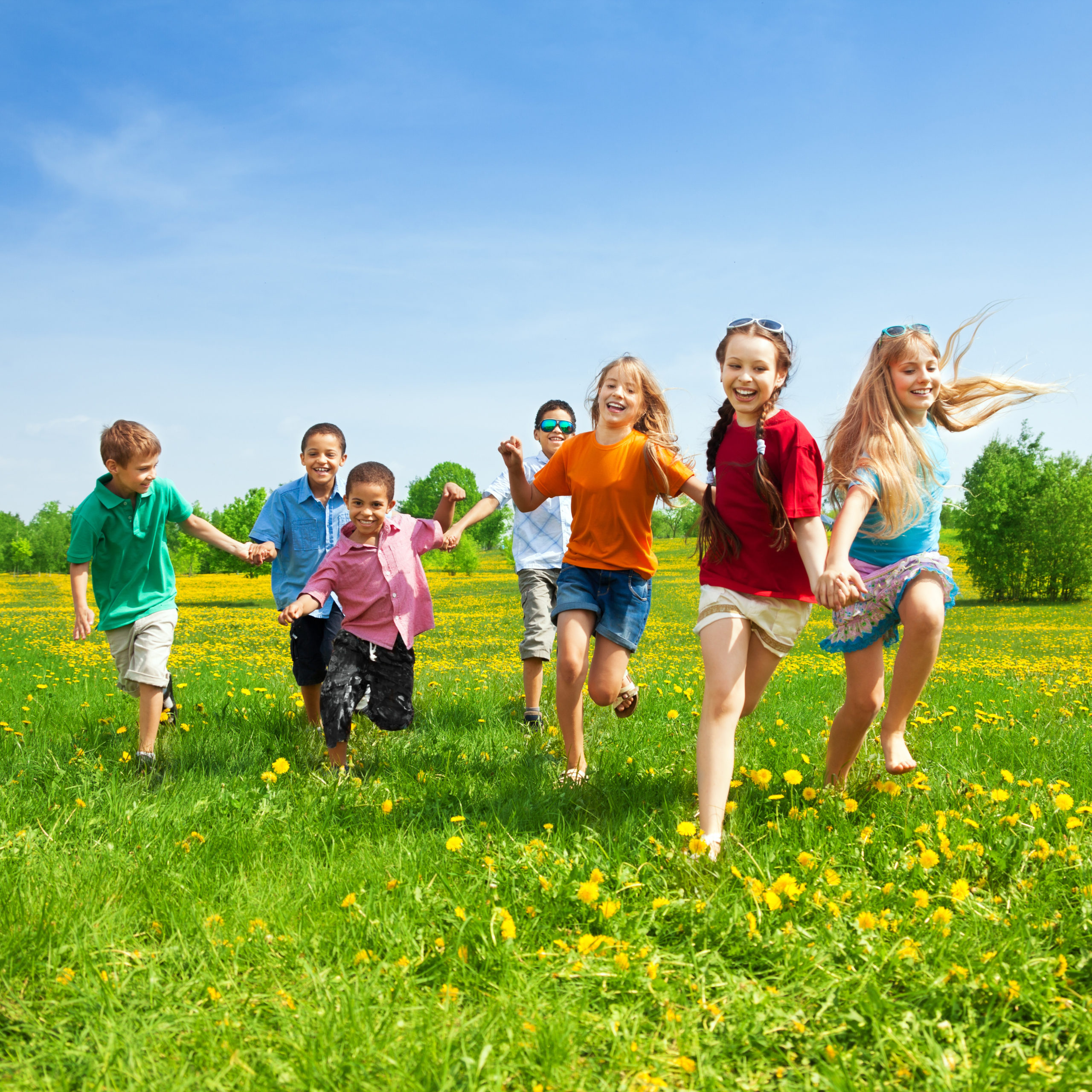 Group of children running and playing during summer time.