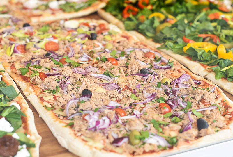 Pizza made with tuna and vegetables as topping