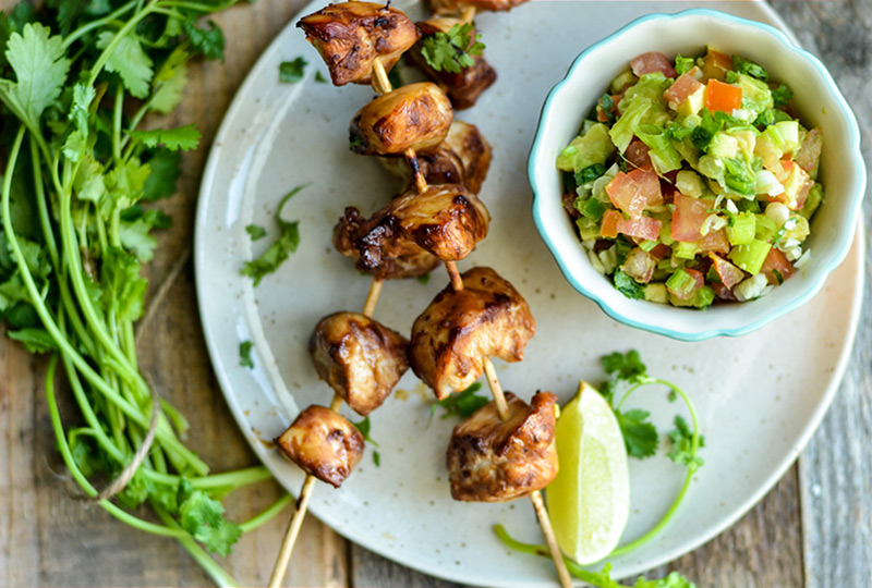 Grilled chicken on skewers with salsa