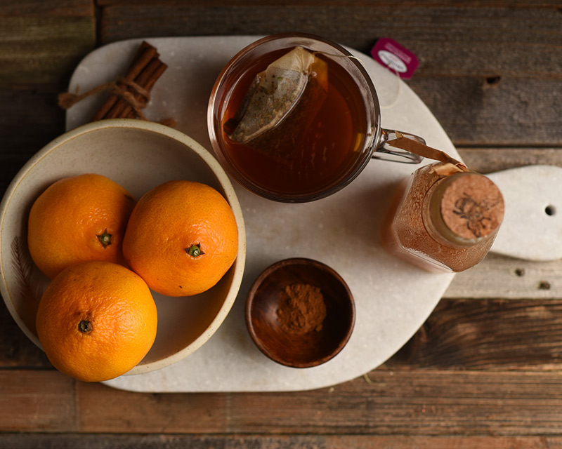 Mandarin oranges, honey and cardamon measured out for making tea-infused mandarin oranges.