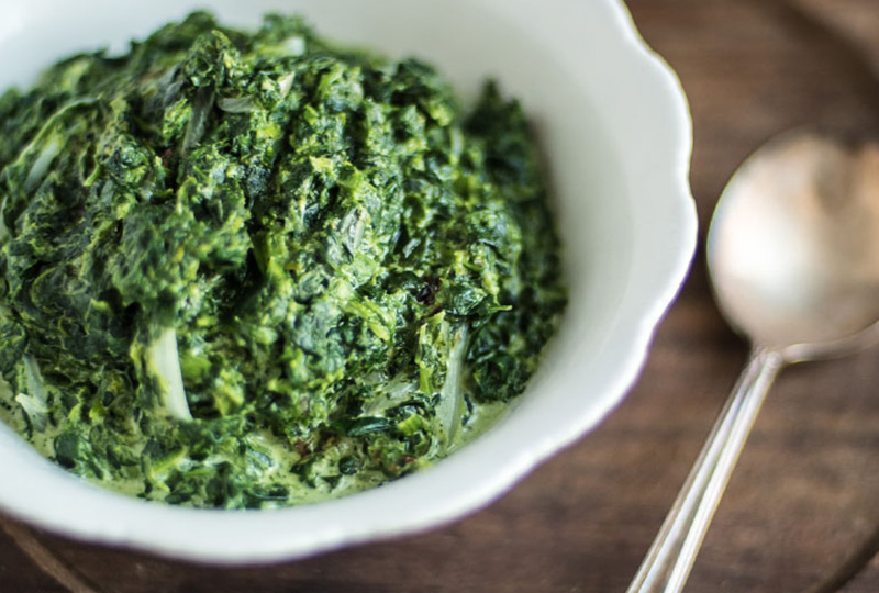 White bowl containing creamed spinach