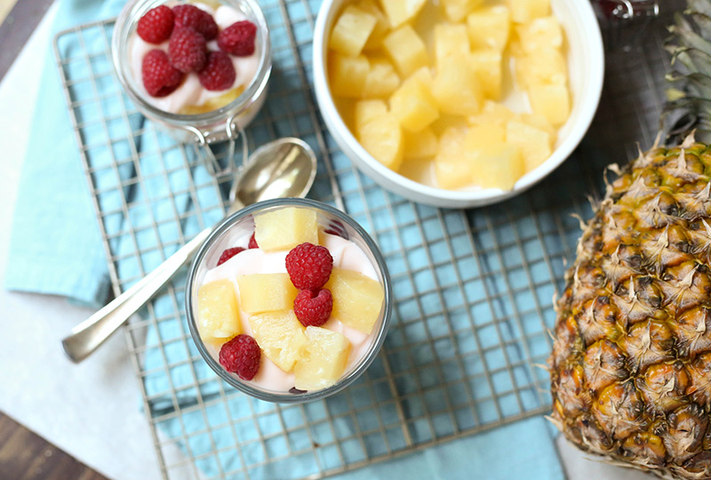 Yogurt, pineapple and raspberries in a parfait glass