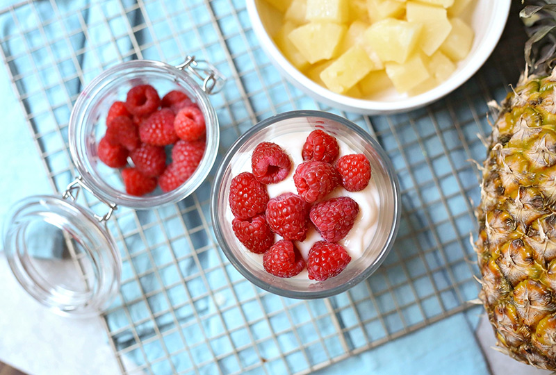 Raspberries top a cup of yogurt