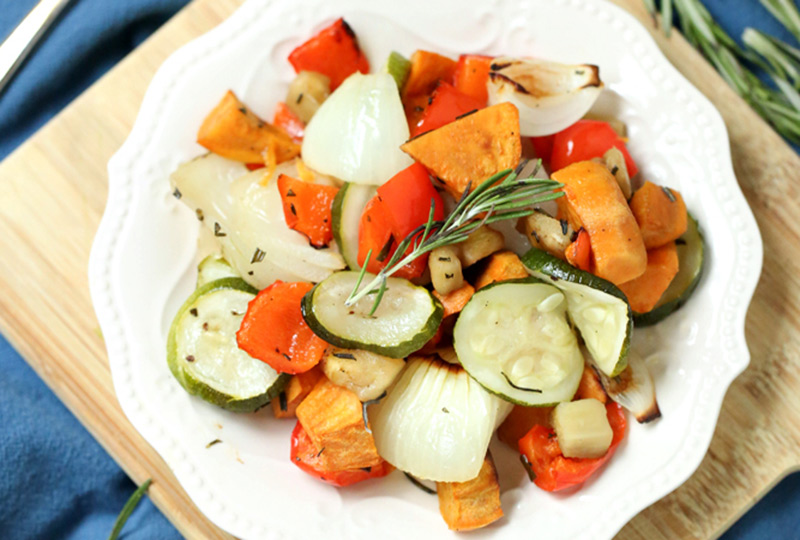 Mixed roasted vegetables on a white plate.