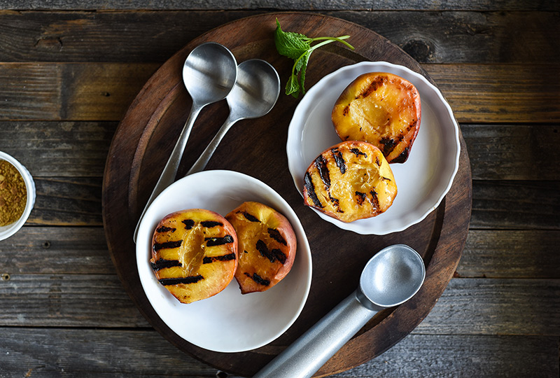 Two bowls with grilled peach halves