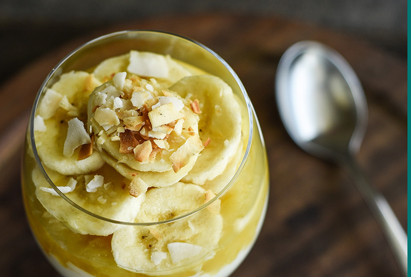 Yogurt parfait with pineapple and banana in a glass.