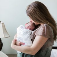 Woman cradles a newborn baby