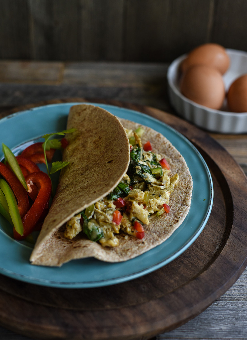 Eggs scrambled with vegetables, folded into a tortilla