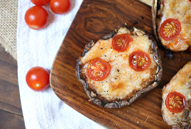 Portabella pizza topped with cherry tomatoes.