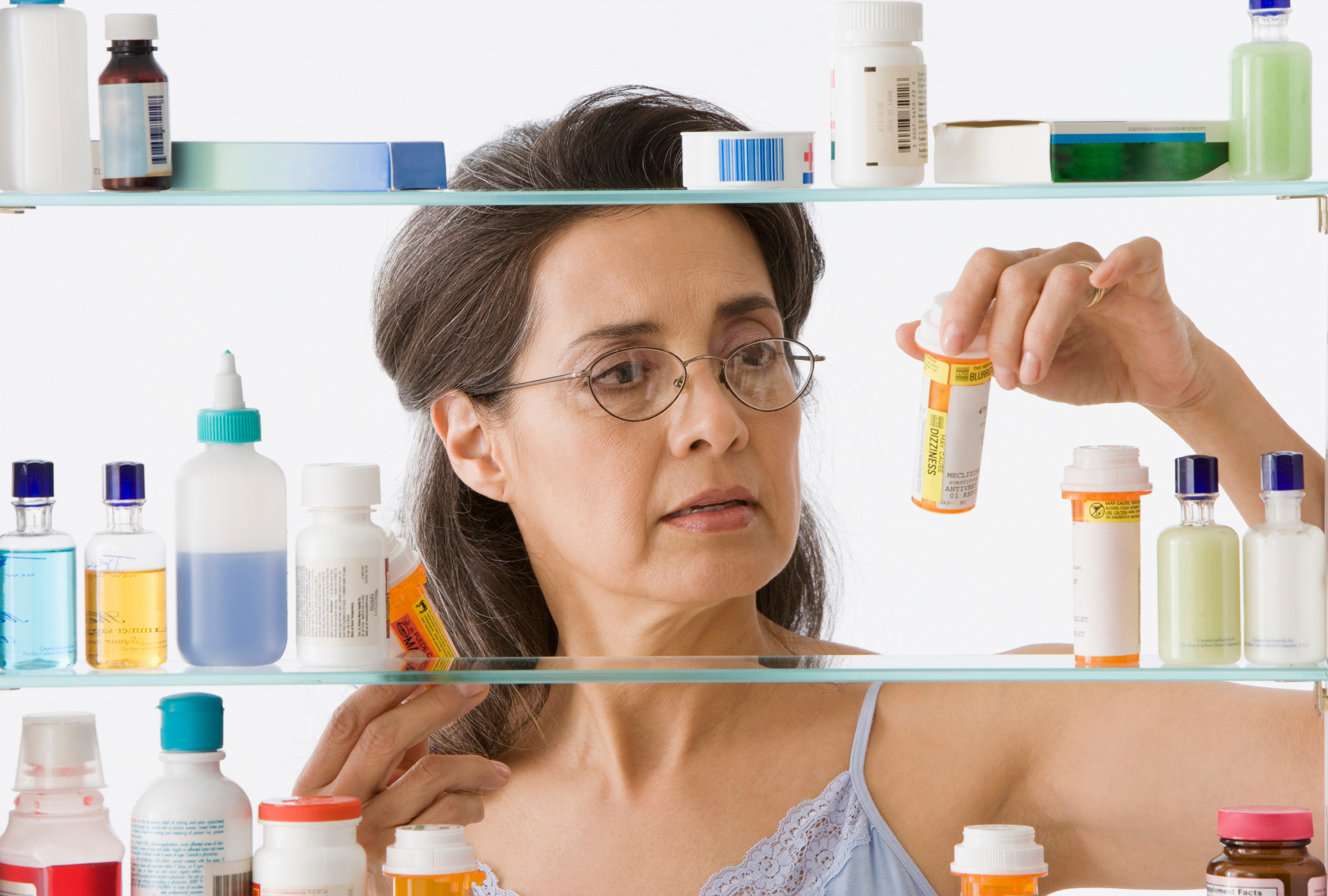 Woman figuring out how to dispose of medication.
