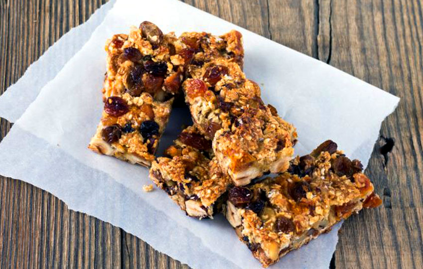 Granola bars laying on parchment paper.
