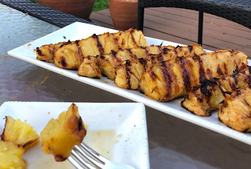 Grilled pineapple spears on a serving platter