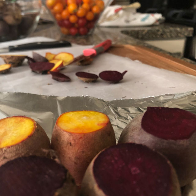 Roasted beets of different colors, prepared for dicing for salad.