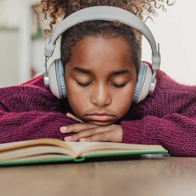 Child falling asleep while reading.