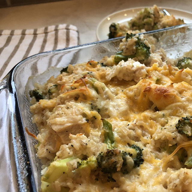 Closeup of a pan of baked cheesy chicken broccoli casserole.