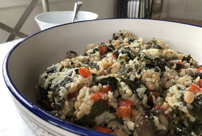 Vegetable risotto in a white serving bowl.