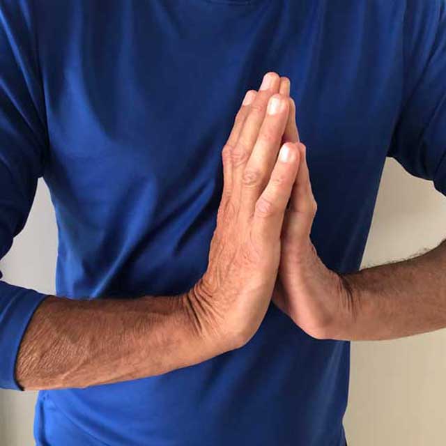 Person performing wrist stretches to relieve wrist pain