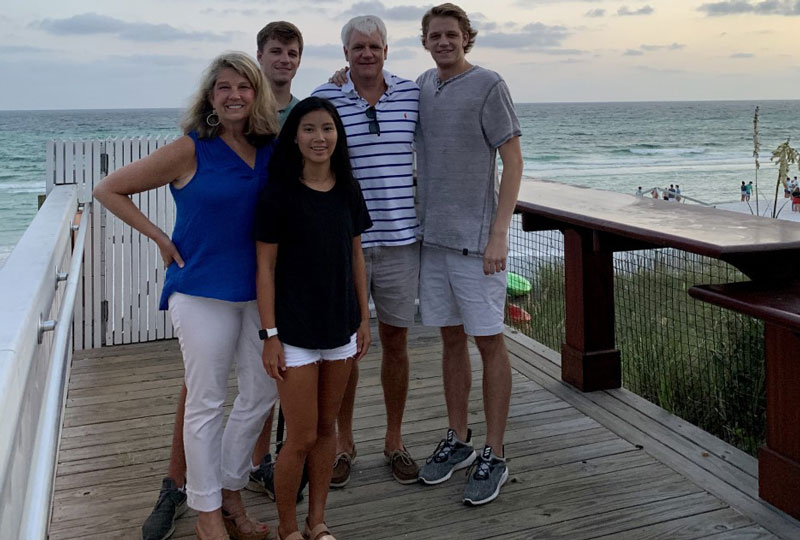 Rachel Hornsby, her husband and three children pose near a beach.