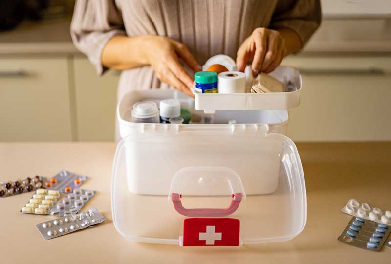 Woman organizing medicine in storage container