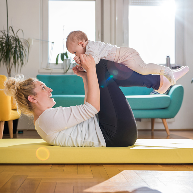 Woman exercising with baby
